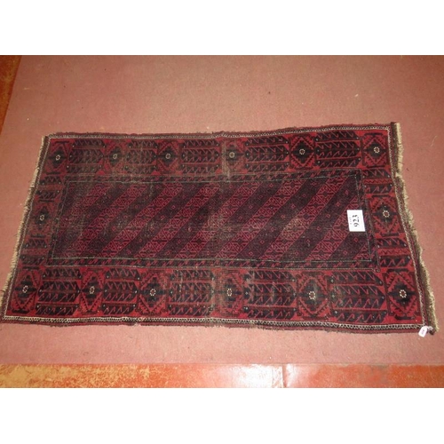 923 - An early 20th Century Persian rug on burgundy ground (even wear). 100cm x 190cm.