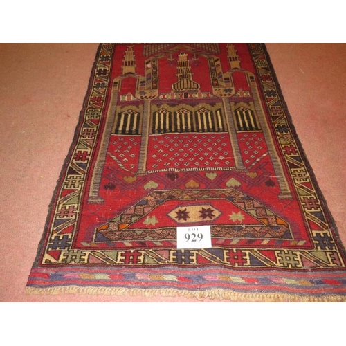 929 - A Persian Beluchi rug. Temple scene on red ground and in good condition. 137cm x 90cm.