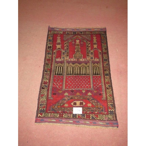 929 - A Persian Beluchi rug. Temple scene on red ground and in good condition. 137cm x 90cm.