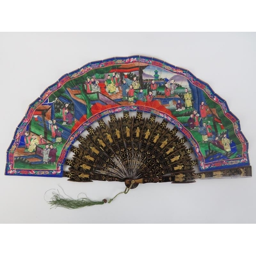 105 - A Chinese Canton lacquered and painted folding fan, 19th century. Decorated to both sides, the black... 