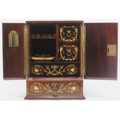 138 - Tobacconalia: An Edwardian rosewood and marquetry inlaid smokers cabinet. Decorated with cherubs, my... 