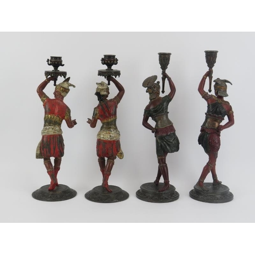 16 - Two pairs of Continental cold painted spelter figural candlesticks, late 19th century. Each pair mod... 