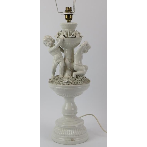 162 - An Italian white porcelain table lamp, 20th century. Modelled with putti. 47 cm height. Condition re... 