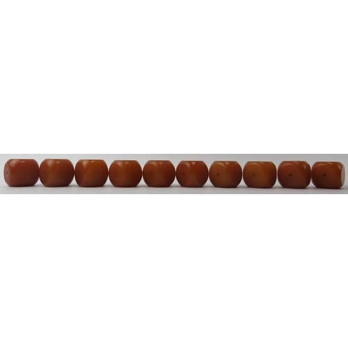 213 - Tribal Art: A group of African bakelite amber coloured cube beads. (10 items) 3.2 cm approximate len... 