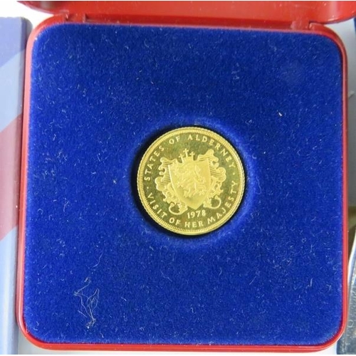 299 - A 9ct gold States of Alderney half sovereign coin, a Guernsey silver proof one pound coin and others... 