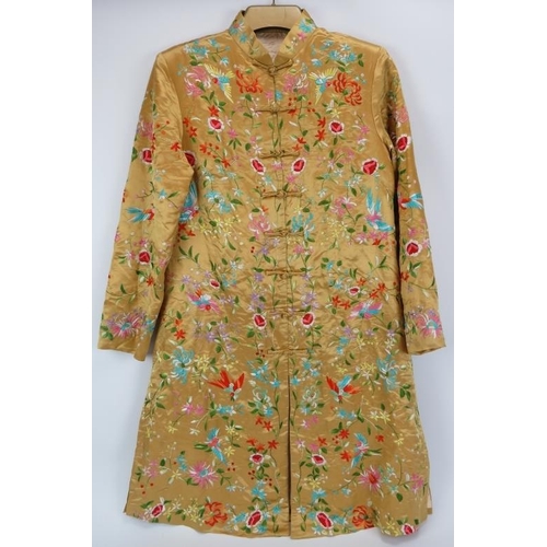 3 - A Chinese embroidered silk jacket, 20th century. Profusely embroidered with birds, flowers and folia... 