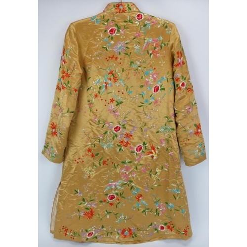 3 - A Chinese embroidered silk jacket, 20th century. Profusely embroidered with birds, flowers and folia... 