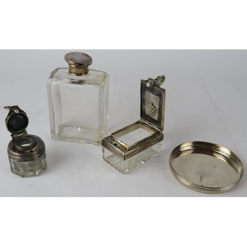 309 - Two mid 19th century silver topped screw down inkwells, a silver topped bottle and silver jar lid. H... 