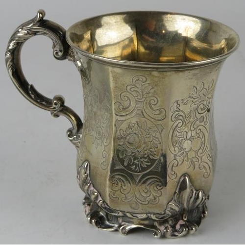 310 - A mid 19th century silver mug of octagonal form raised on an acanthus leaf base, scrollate handle an... 