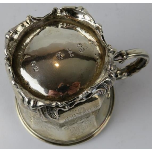 310 - A mid 19th century silver mug of octagonal form raised on an acanthus leaf base, scrollate handle an... 