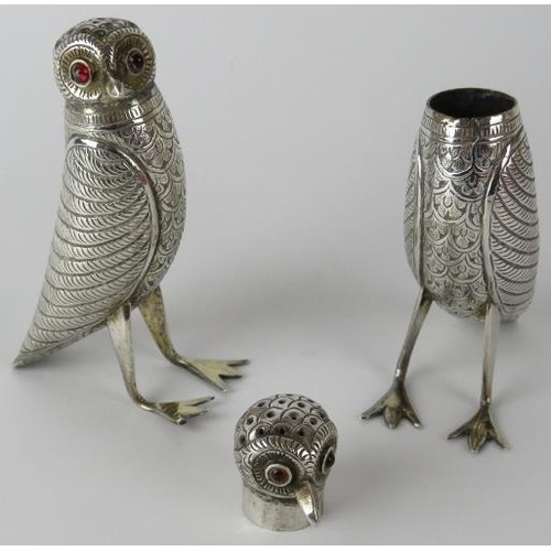 312 - A pair of Indian white metal pepperettes in the form of birds with red glass eyes. Height 9cm. Gross... 