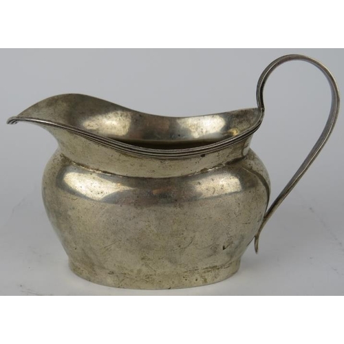 323 - A silver Georgian style cream jug, hallmarked for Chester, maker and date letter rubbed. Height 8cm.... 