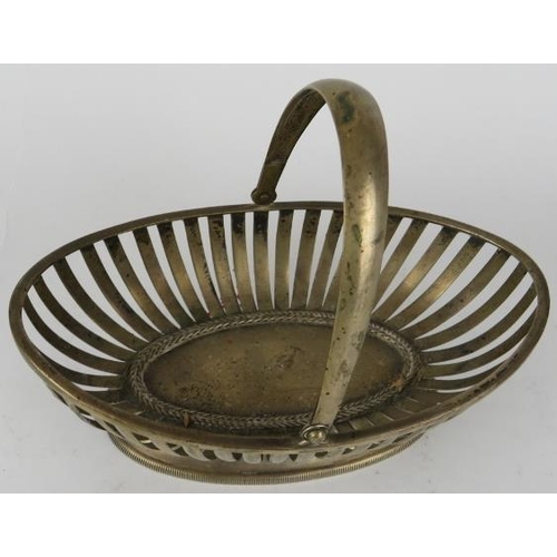 324 - A French silver bonbon basket of oval strap work form with hinged handle. Bears French silver marks.... 