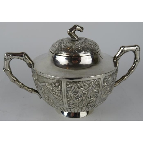 331 - A late 19th century Chinese silver covered sucrier with embossed panels and bamboo style handles and... 