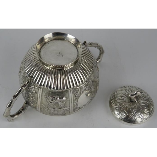 331 - A late 19th century Chinese silver covered sucrier with embossed panels and bamboo style handles and... 