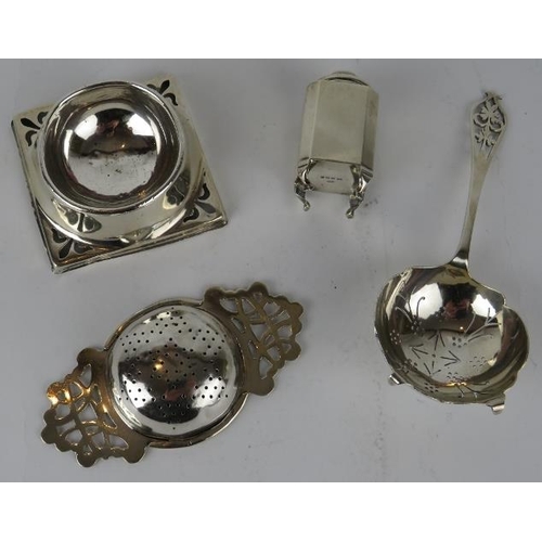 333 - A silver tea strainer and stand, a similar silver tea strainer and an Art Deco pepperette. Various h... 