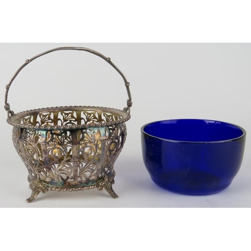 344 - A pierced silver bonbon basket with blue glass liner, hallmarked for Birmingham 1935 (Jubilee mark),... 