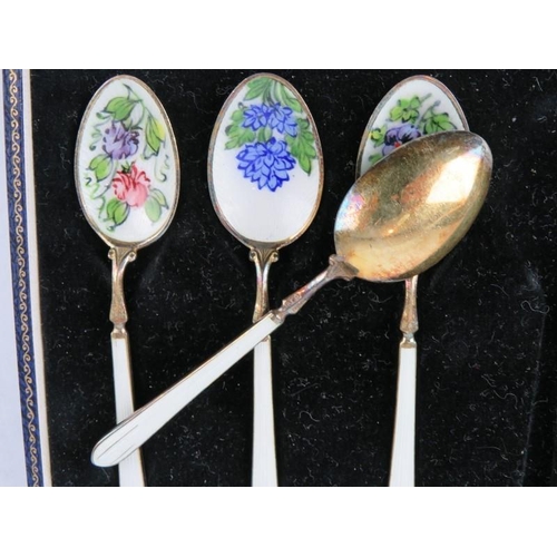 345 - A boxed set of six silver gilt coffee spoons enamelled with flowers, hallmarked for Birmingham 1963,... 