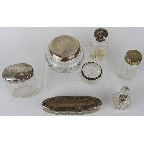 347 - Seven mixed silver mounted bottles and jars, various hallmarks.  Weighable silver 79 grams.