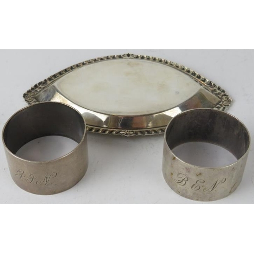 348 - An oval silver pin dish with gadrooned rim (marks rubbed), and a pair of Walker & Hall silver napkin... 