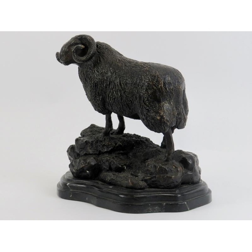 35 - A bronzed metal figure of a ram on a rocky outcrop, 20th century. Supported on a marble base. 21.3 c... 