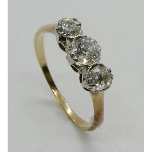 366 - A three stone diamond ring, the graduated three old cut diamonds, claw and part rub-over set, in whi... 