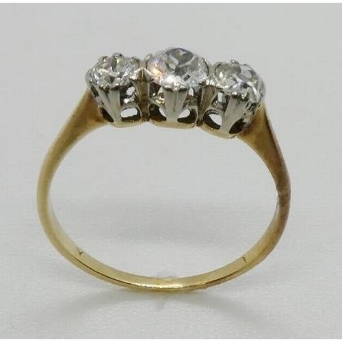 366 - A three stone diamond ring, the graduated three old cut diamonds, claw and part rub-over set, in whi... 