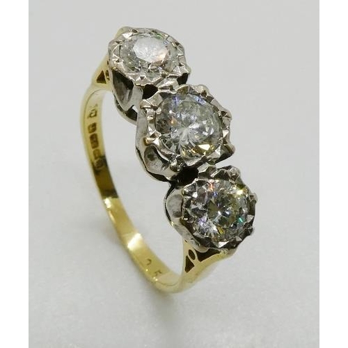 367 - A three stone diamond ring, the graduated round brilliant cut diamonds illusion set in platinum and ... 