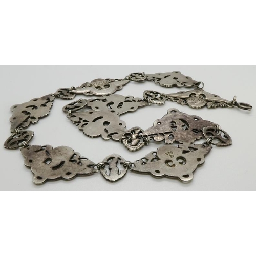 370 - A Vintage Silver metal necklace with embossed trophies/plaques, stamped 800, 400mm long.44.4gms. All... 