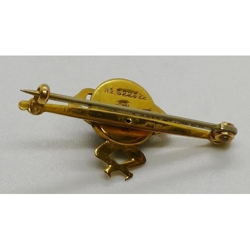 381 - A WWI period 9ct gold novelty Touch Wood figural brooch set with a carved nut, 2.1gms. All weights m... 