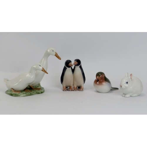 52 - A group of four Royal Copenhagen porcelain figurines. Comprising a figural group of two geese, numbe... 