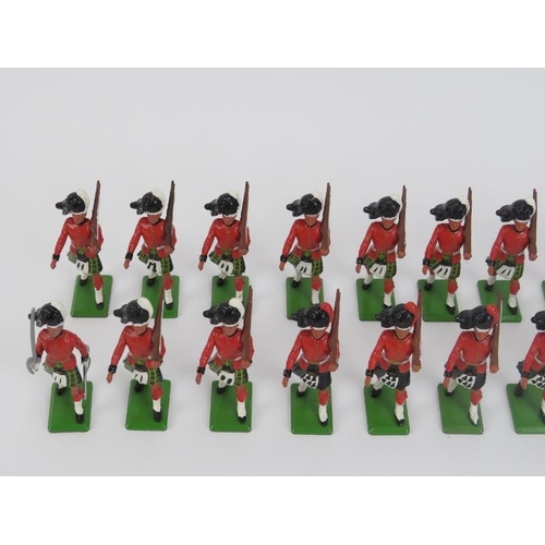 58 - A group of vintage cold painted metal British model soldier figures. Britains Highlander figures inc... 