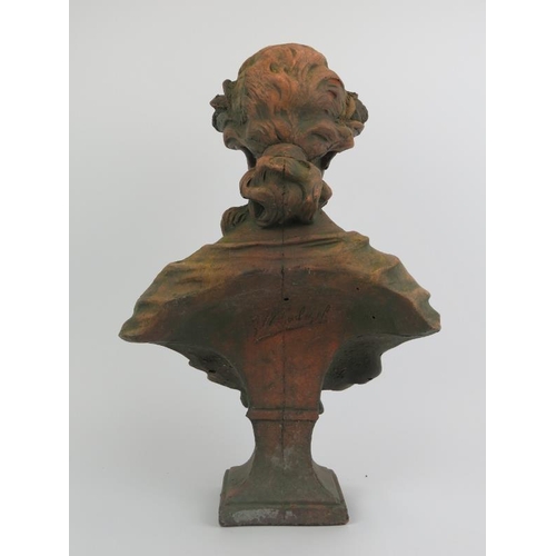 76 - A large terracotta bust of a maiden after Gustave Van Vaerenbergh (1873 - 1927). Signed G. V. Vaeren... 