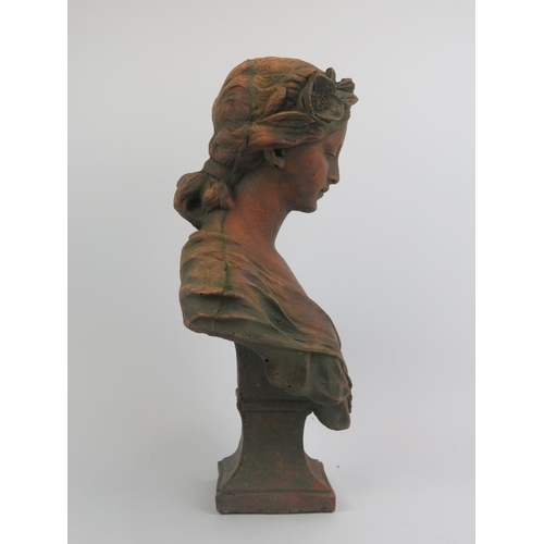 76 - A large terracotta bust of a maiden after Gustave Van Vaerenbergh (1873 - 1927). Signed G. V. Vaeren... 