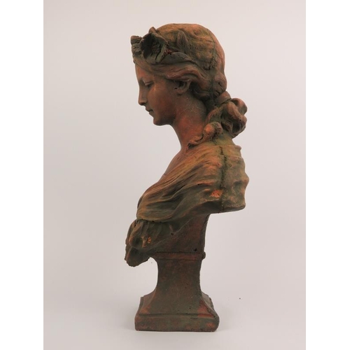 76 - A large terracotta bust of a maiden after Gustave Van Vaerenbergh (1873 - 1927). Signed G. V. Vaeren... 