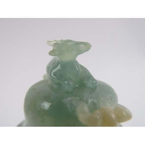 83 - A Chinese carved jadeite tripod censer and cover, 20th century. Decorated with deer head ring handle... 