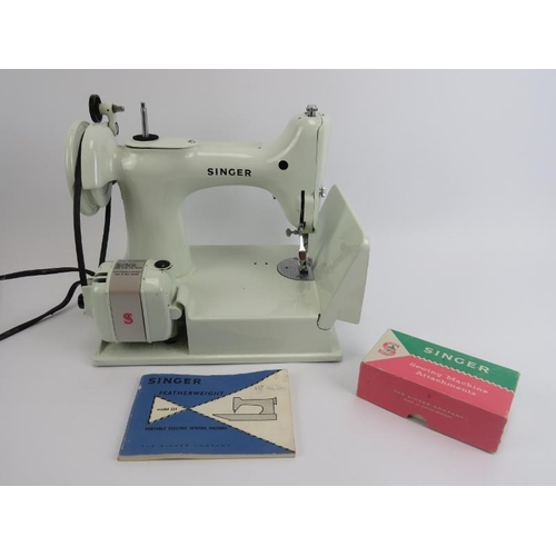 86 - A Singer Featherweight Model 221 portable electric sewing machine. The white Model 221 sewing machin... 