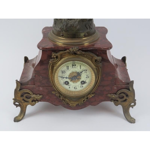 95 - A French gilt metal mounted red marble mantle clock, late 19th/early 20th century. Mounted with a br... 