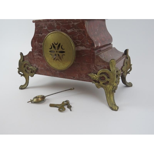 95 - A French gilt metal mounted red marble mantle clock, late 19th/early 20th century. Mounted with a br... 