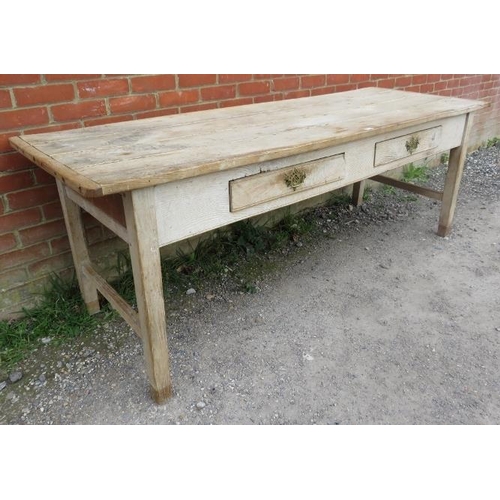 705 - An antique scrubbed elm farmhouse kitchen table, having two short frieze drawers with brass handles,... 