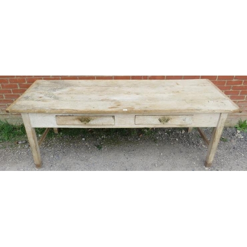 705 - An antique scrubbed elm farmhouse kitchen table, having two short frieze drawers with brass handles,... 