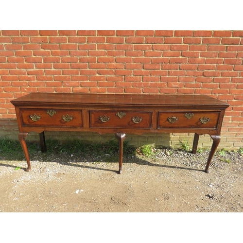 706 - An 18th century oak sideboard, housing three short crossbanded drawers with pierced brass ‘batwing’ ... 