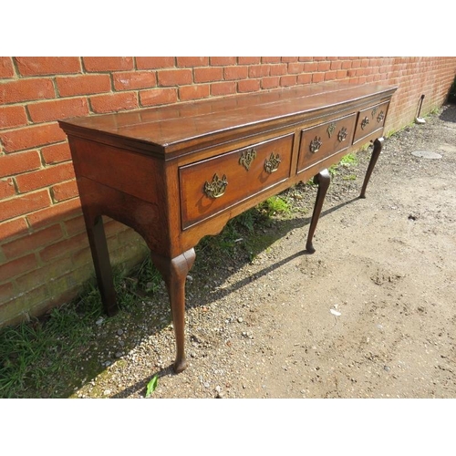 706 - An 18th century oak sideboard, housing three short crossbanded drawers with pierced brass ‘batwing’ ... 