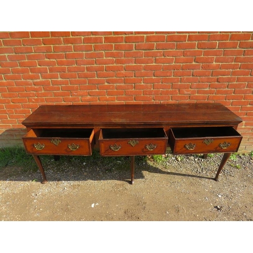 706 - An 18th century oak sideboard, housing three short crossbanded drawers with pierced brass ‘batwing’ ... 