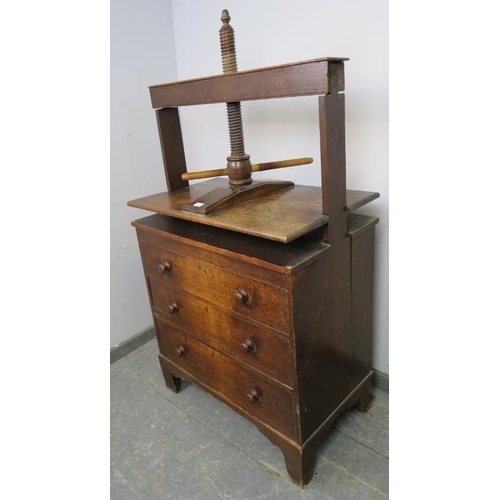 710 - An early 19th century oak chest of small proportions with clothes press, housing three long drawers ... 