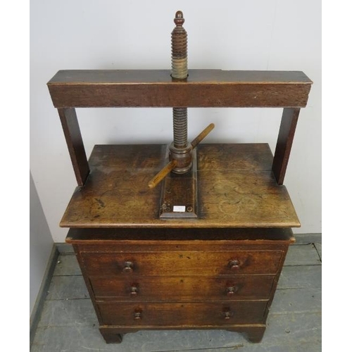 710 - An early 19th century oak chest of small proportions with clothes press, housing three long drawers ... 