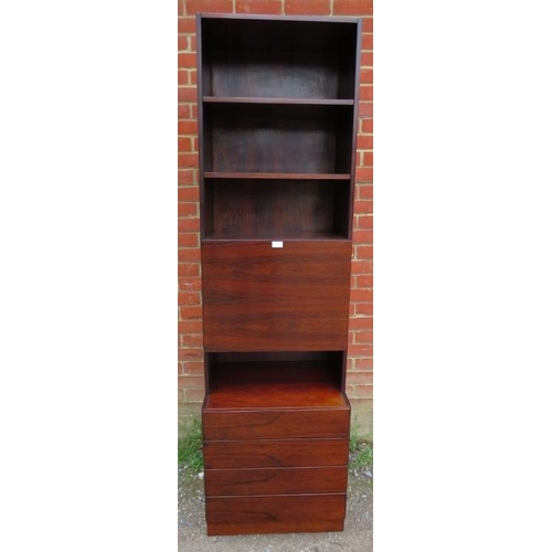 714 - A mid-century Danish hardwood tall drinks cabinet, having three open shelves above a fall-front mixi... 