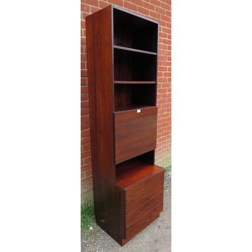 714 - A mid-century Danish hardwood tall drinks cabinet, having three open shelves above a fall-front mixi... 