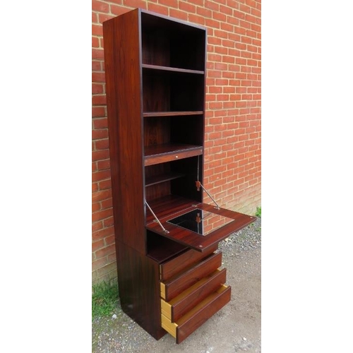 714 - A mid-century Danish hardwood tall drinks cabinet, having three open shelves above a fall-front mixi... 