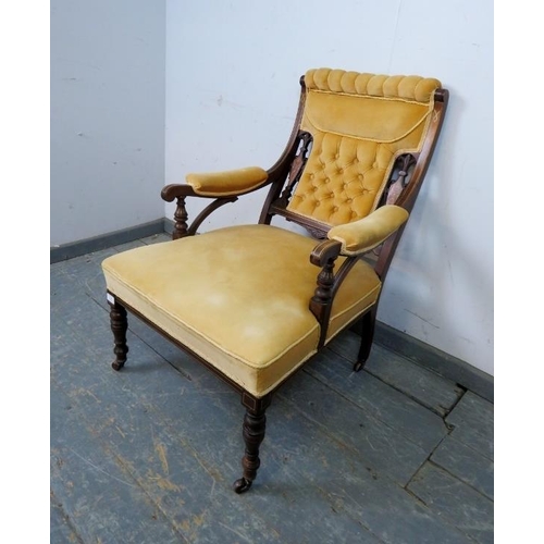 720 - An Edwardian mahogany low library chair, the carved and pierced back with marquetry inlay, reupholst... 